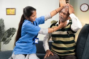 NURSE TREATING ELDERLY 